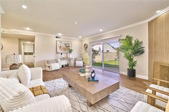 a living room with furniture potted plant and a table