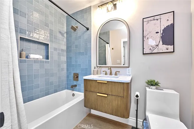 a bathroom with a tub a sink and a mirror