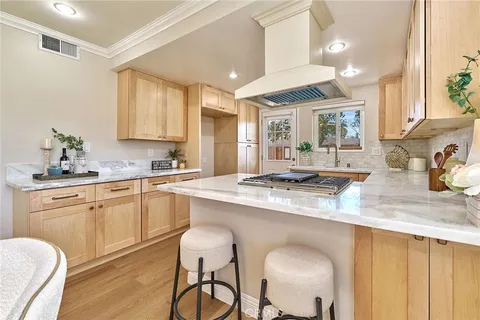 a kitchen with stainless steel appliances granite countertop a sink and cabinets