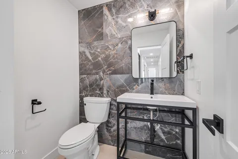 a bedroom with a bed and a view of living room