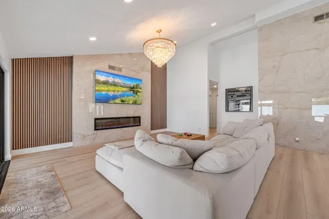 a bedroom with a large bed and a chandelier