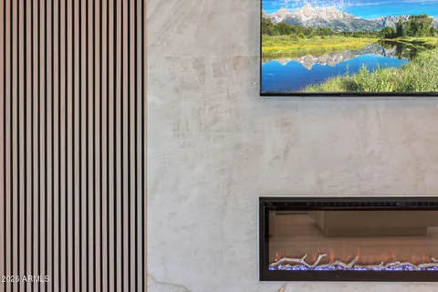a spacious bedroom with a bed and a chandelier