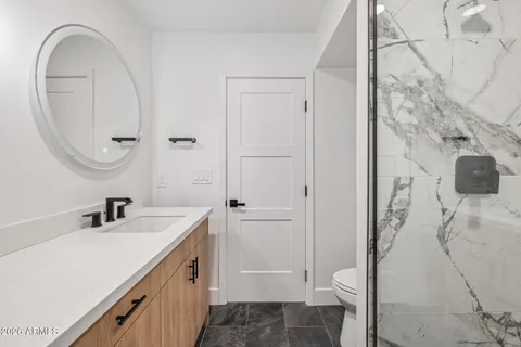 a bathroom with a tub a toilet and a shower