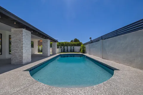 a view of a swimming pool with an outdoor seating