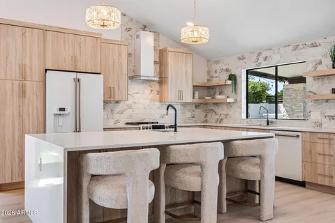 a large kitchen with a table and chairs