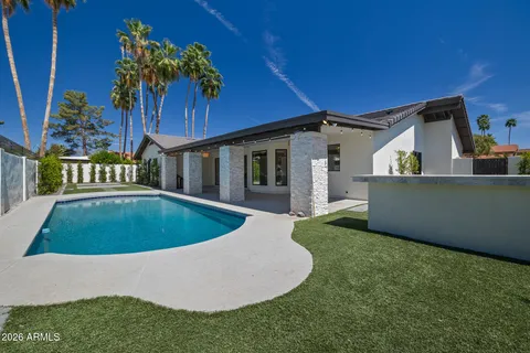 a kitchen with granite countertop white cabinets and stainless steel appliances