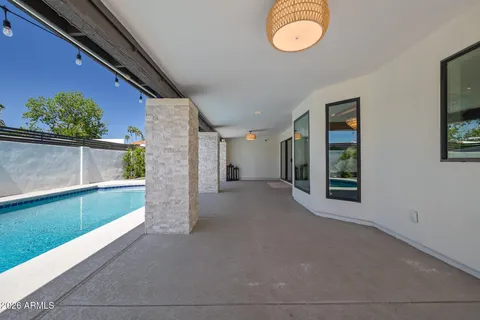 a spacious bedroom with a bed and a flat screen tv