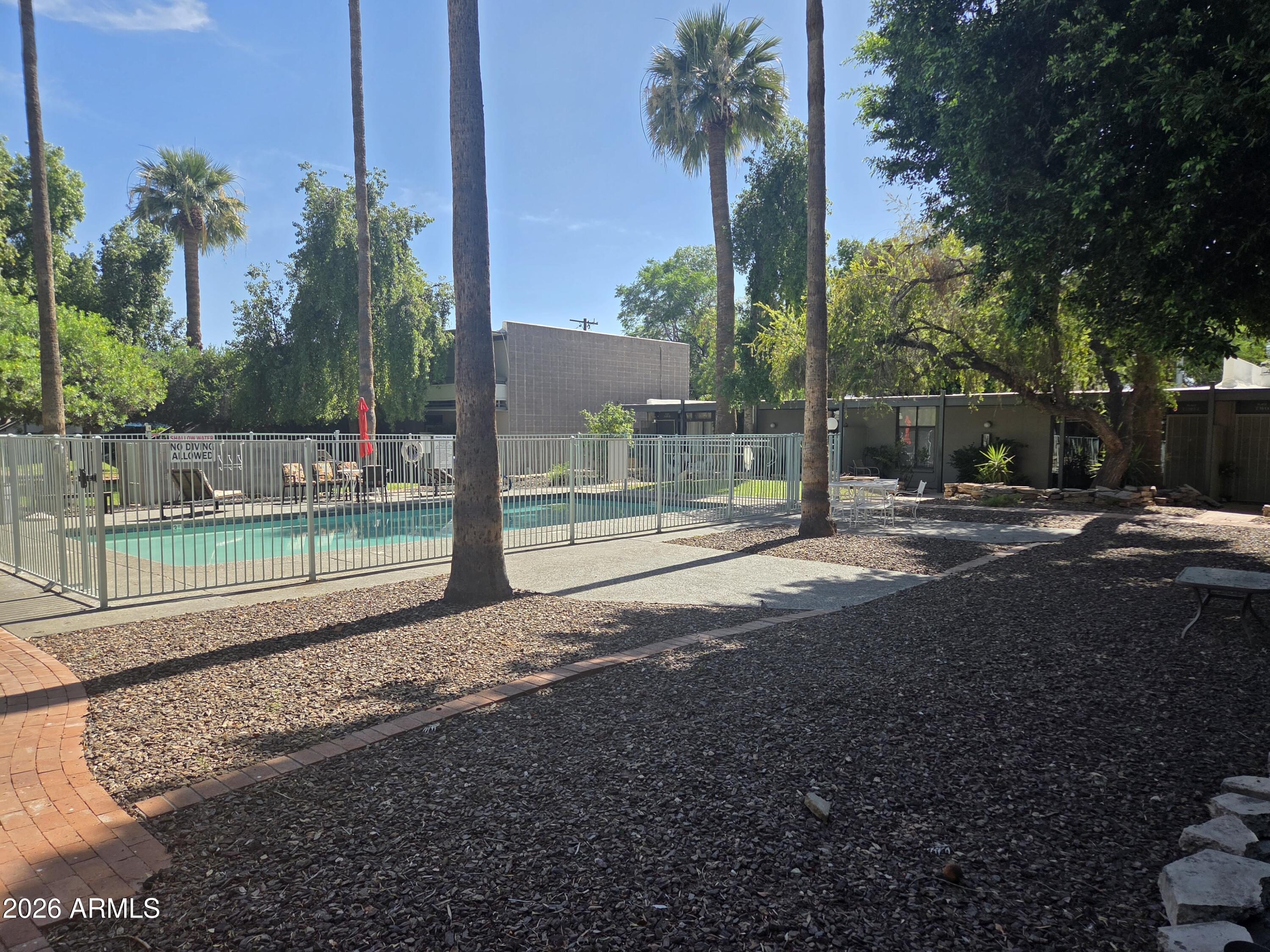 1101 East Bethany Home Road, Unit 7 Phoenix, AZ 85014 - Photo 13 of 14 a backyard of a house with lots of green space
