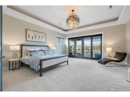 a spacious bedroom with a bed and a large window