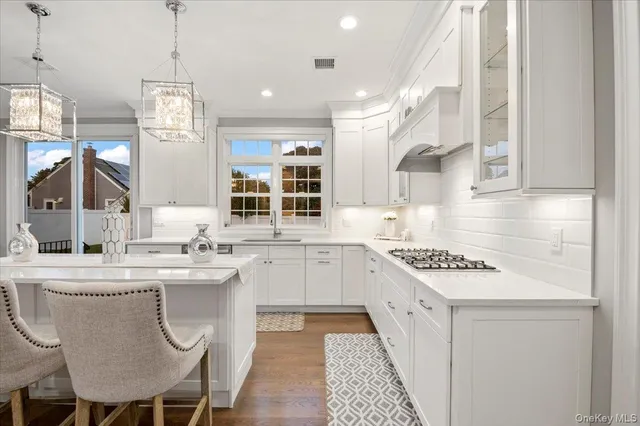 a kitchen with a sink stove and cabinets