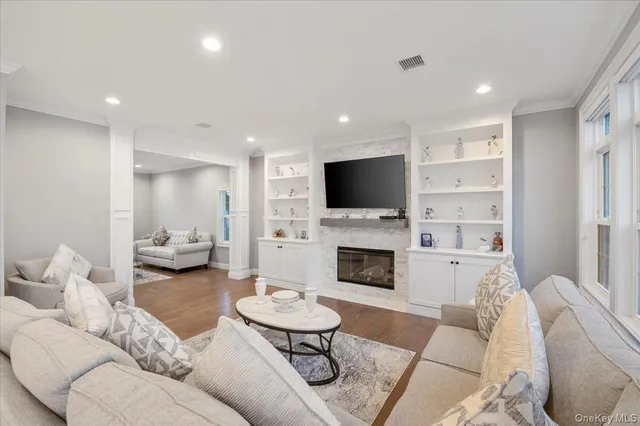 a living room with furniture a fireplace and a flat screen tv