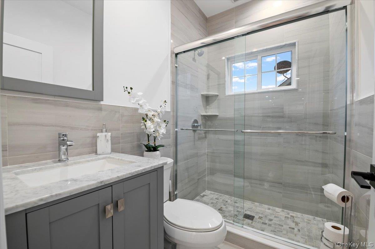 1427 Bellmore Road North Bellmore, NY 11710 - Photo 20 of 38 a bathroom with a sink toilet and shower