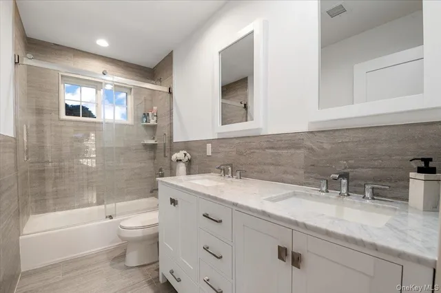 a view of a hallway with wooden floor and windows