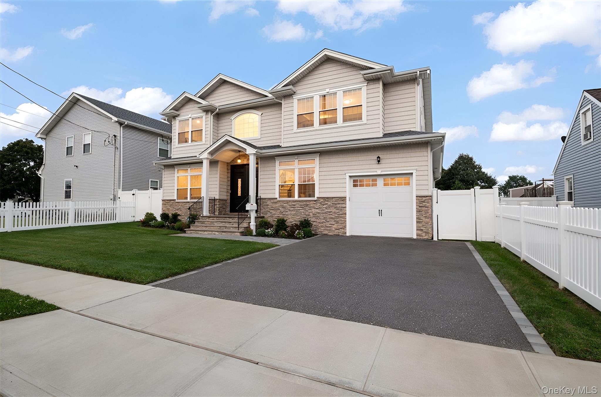1427 Bellmore Road North Bellmore, NY 11710 - Photo 32 of 38 a front view of a house with a yard and garage