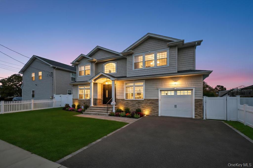 1427 Bellmore Road North Bellmore, NY 11710 - Photo 4 of 38 a front view of a house with a yard and garage