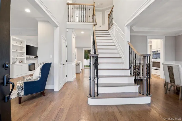 a view of entryway and hall with wooden floor