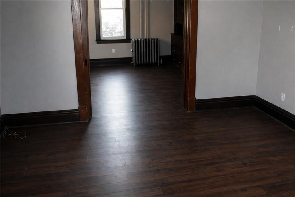 624 Kier Road Salina, PA 15680 - Photo 7 of 19 an empty room with wooden floor and windows