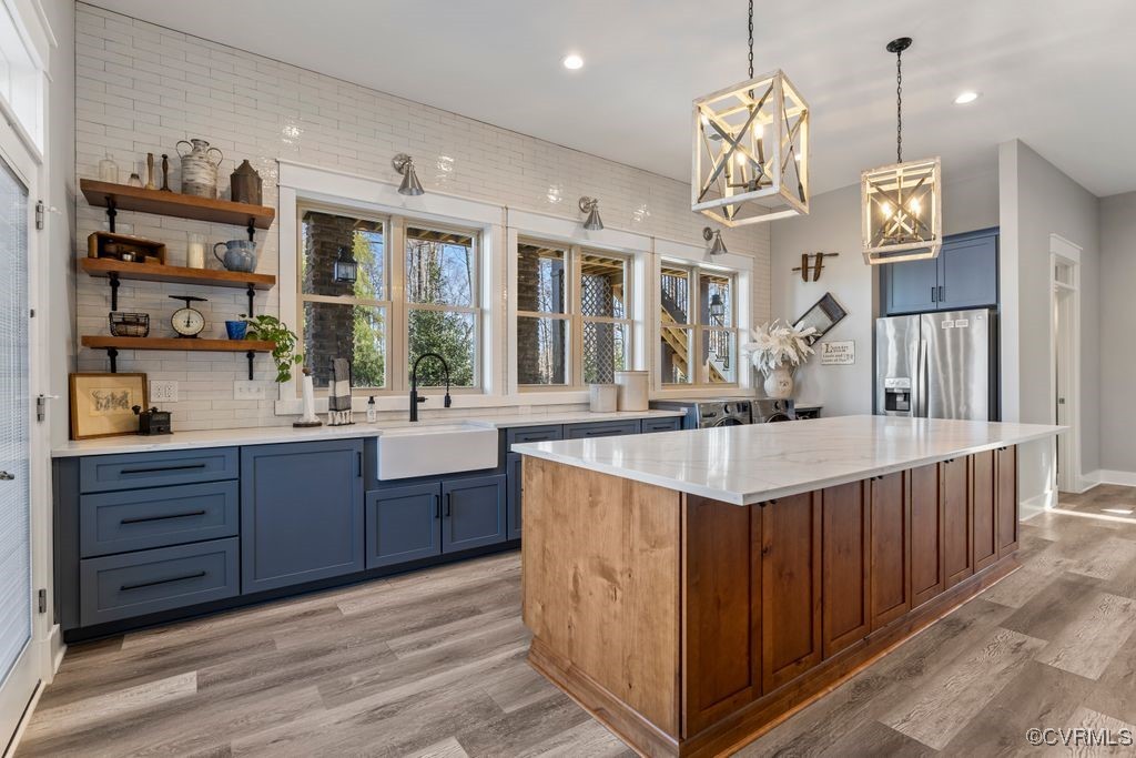 14106 Old Fort Drive Midlothian, VA 23113 - Photo 14 of 47 a very nice looking kitchen with a center island wooden floor and stainless steel appliances