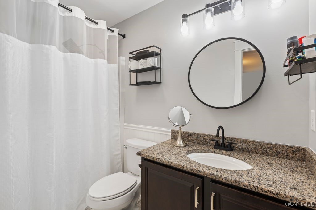 14106 Old Fort Drive Midlothian, VA 23113 - Photo 26 of 47 a bathroom with a granite countertop toilet a sink and a mirror