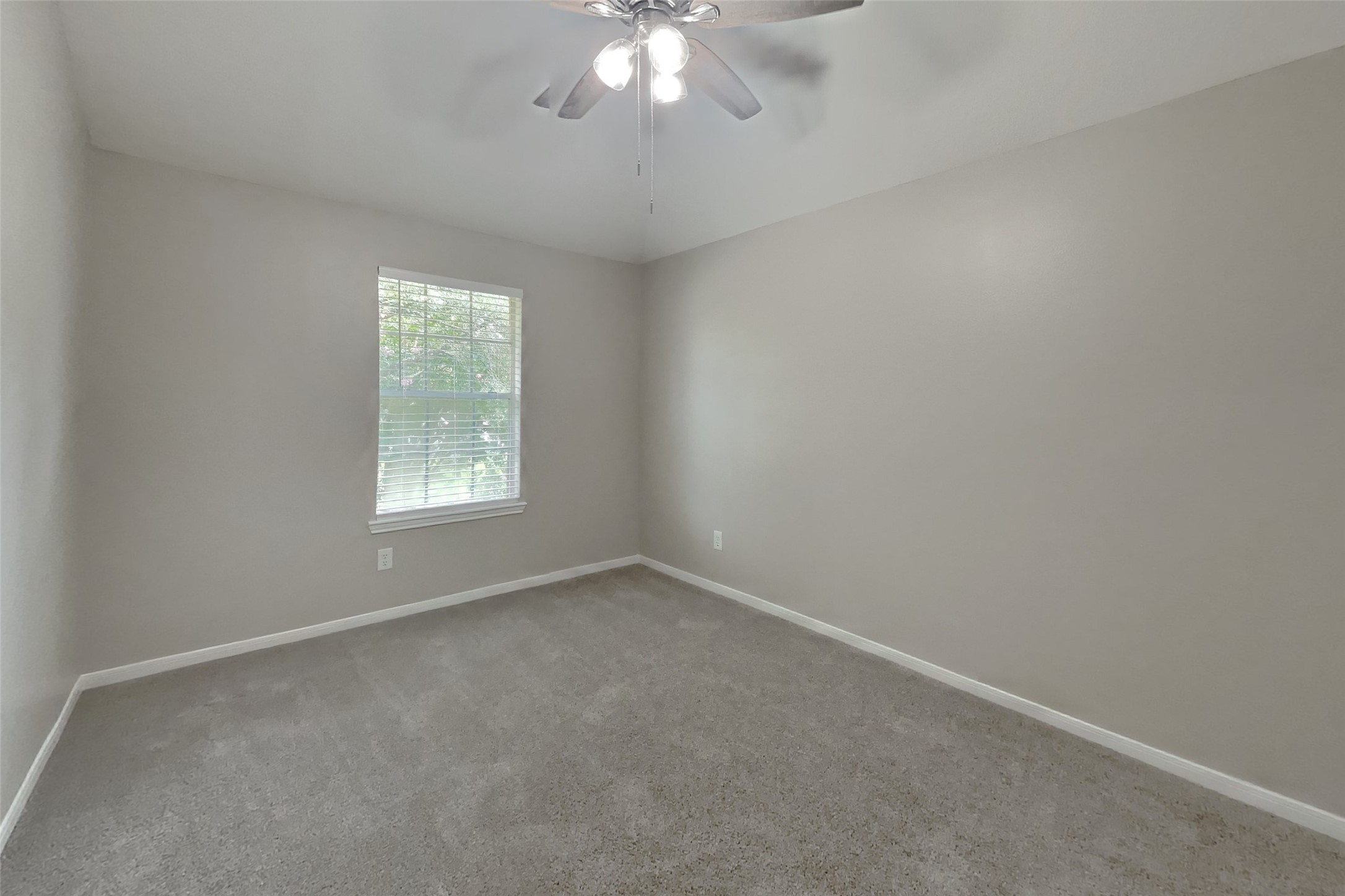619 Bending Bough Drive Spring, TX 77388 - Photo 13 of 22 an empty room with a chandelier fan and windows