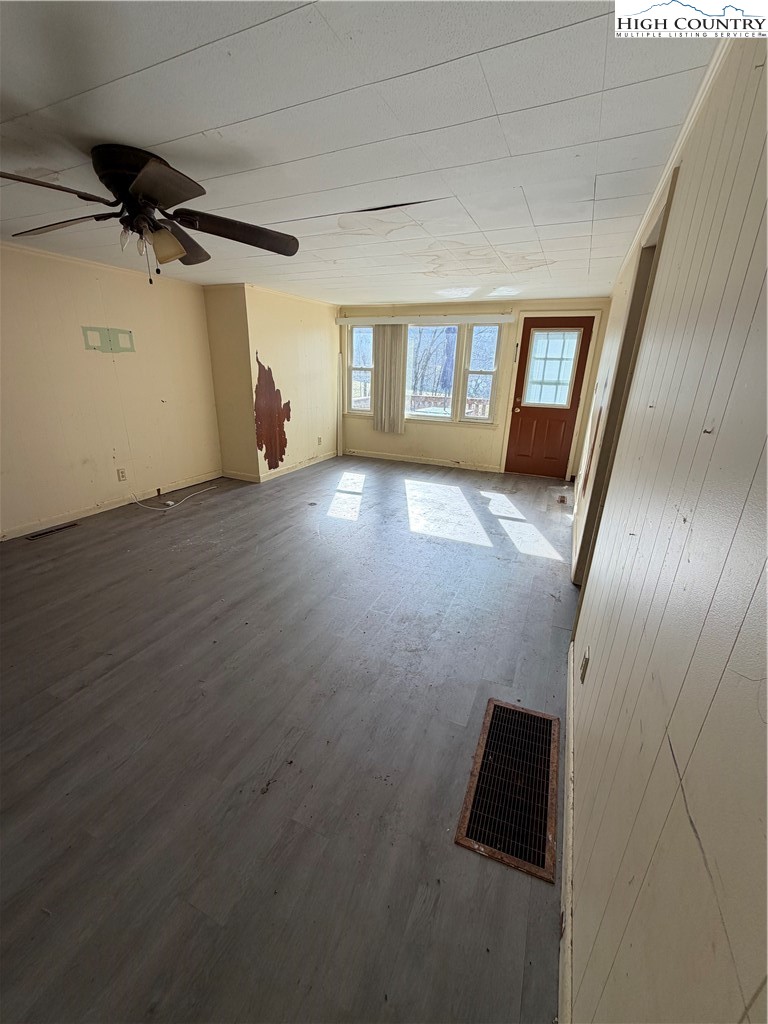 733 Clark Swift Road Vilas, NC 28692 - Photo 32 of 36 an empty room with wooden floor and windows