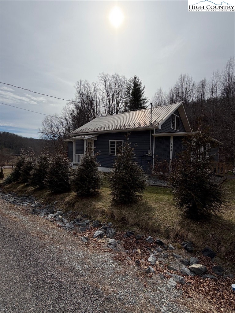 733 Clark Swift Road Vilas, NC 28692 - Photo 4 of 36 a view of a house with backyard and garden