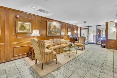 a living room with furniture and a dining table