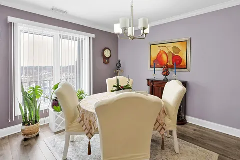 a dining room with furniture and wooden floor