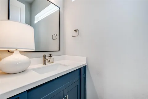a bathroom with a sink vanity and a mirror