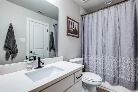 a bathroom with a sink a toilet and mirror