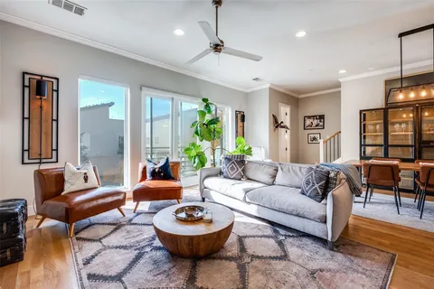 a living room with furniture a rug and a chandelier