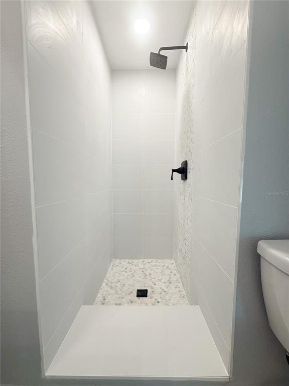 14000 Miramar Avenue, Unit A Madeira Beach, FL 33708 - Photo 11 of 20 a bathroom with a shower