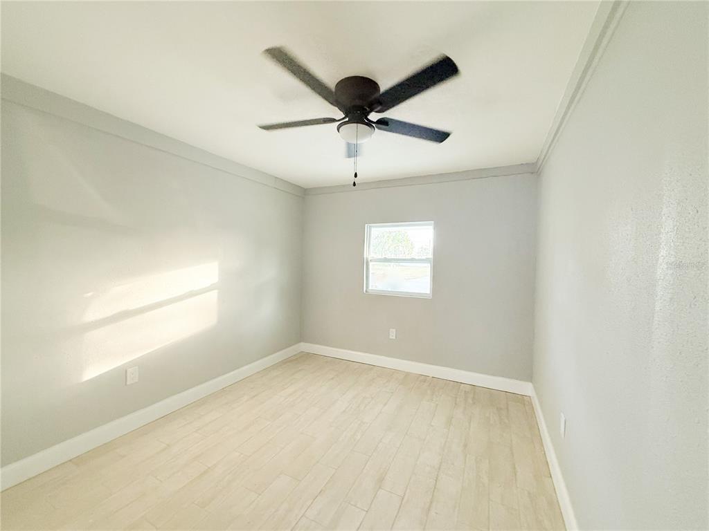 14000 Miramar Avenue, Unit A Madeira Beach, FL 33708 - Photo 14 of 20 an empty room with ceiling fan and windows