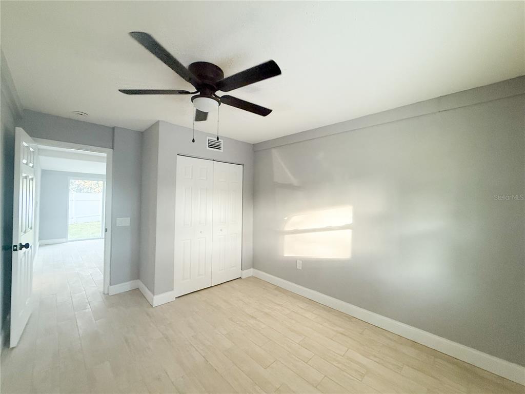 14000 Miramar Avenue, Unit A Madeira Beach, FL 33708 - Photo 15 of 20 an empty room with windows and fan