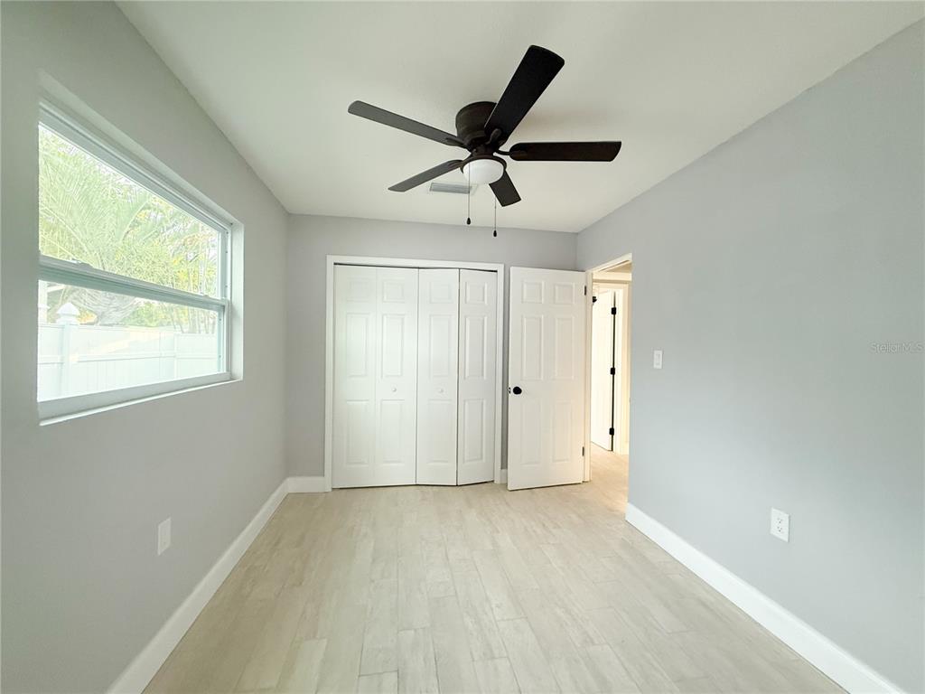 14000 Miramar Avenue, Unit A Madeira Beach, FL 33708 - Photo 16 of 20 a view of a livingroom with a ceiling fan and window