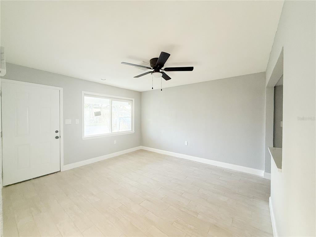 14000 Miramar Avenue, Unit A Madeira Beach, FL 33708 - Photo 4 of 20 a view of empty room with ceiling fan