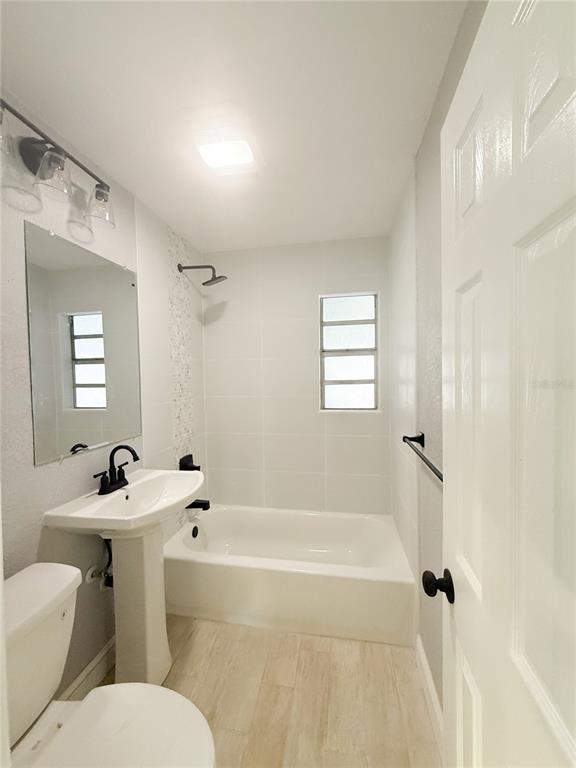 14000 Miramar Avenue, Unit A Madeira Beach, FL 33708 - Photo 5 of 20 a bathroom with a sink mirror toilet and bathtub