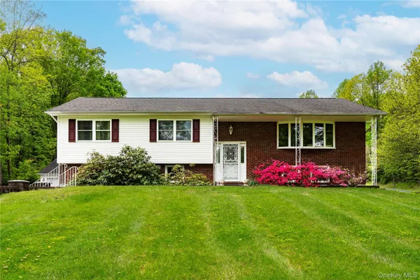 a front view of house with yard and green space