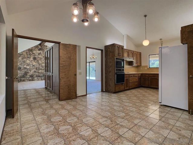a view of a kitchen with a refrigerator and microwave