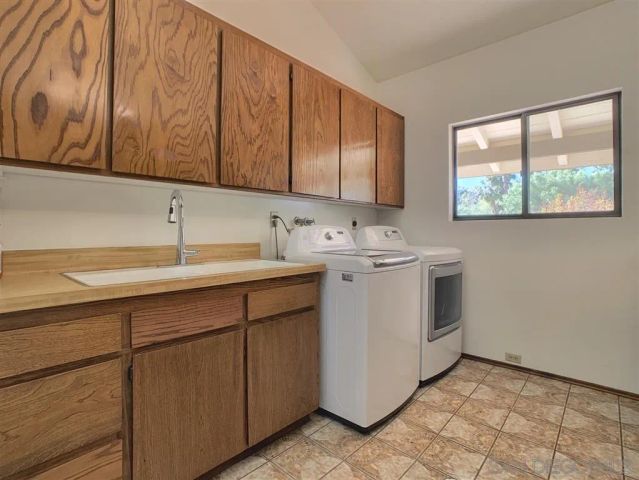 a bathroom with a granite countertop sink and mirror