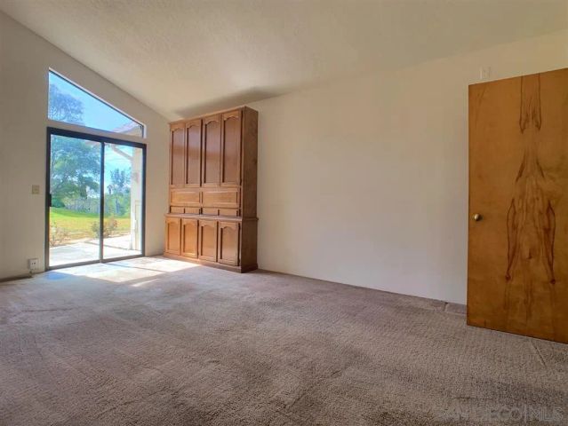 a view of a hallway with chandelier and entryway