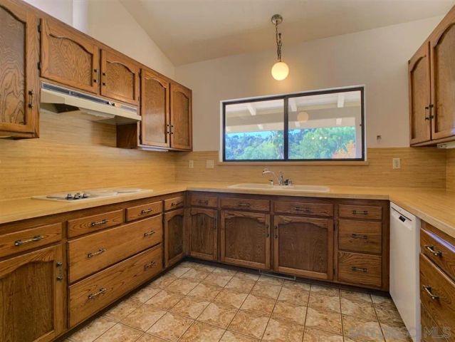 a kitchen with stainless steel appliances granite countertop a sink and cabinets