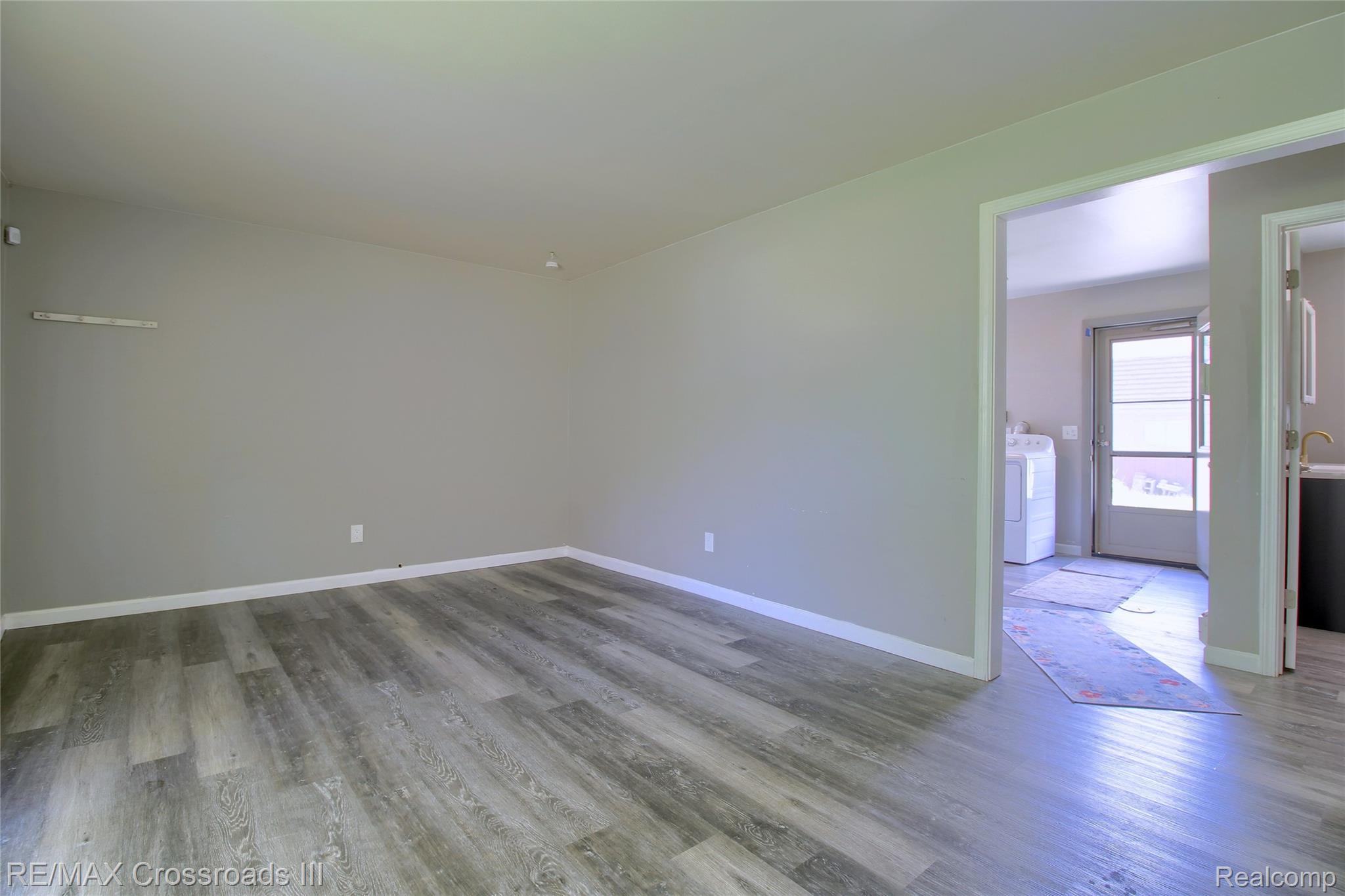 41509 Riggs Road Belleville, MI 48111 - Photo 5 of 26 Neutral wall colors with wood-finish flooring