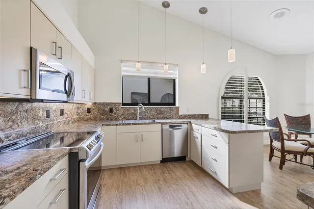 a bathroom with a granite countertop sink a mirror a vanity and a shower