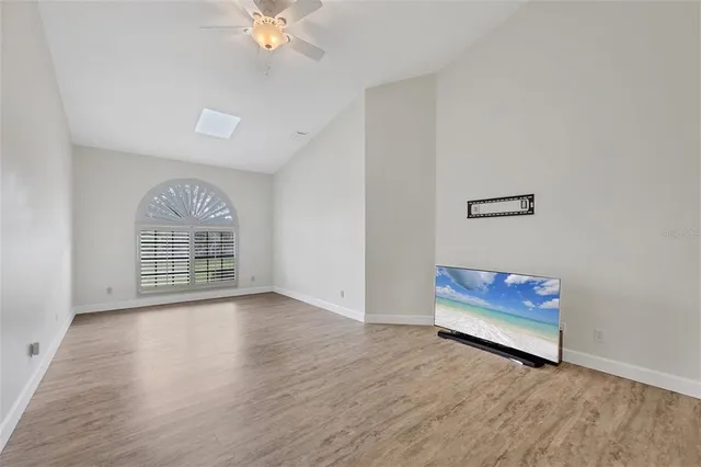 a living room with furniture and a floor to ceiling window