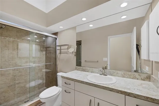 an aerial view of residential houses with outdoor space and trees