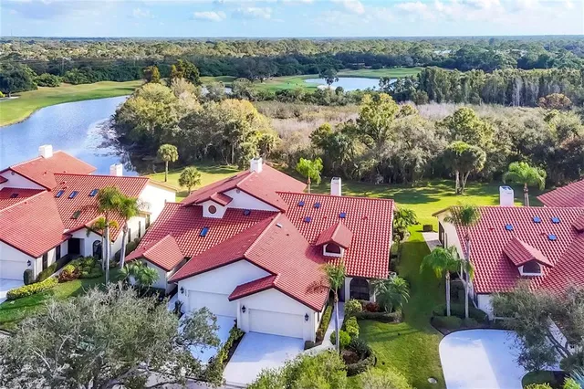 an aerial view of residential houses with outdoor space and river