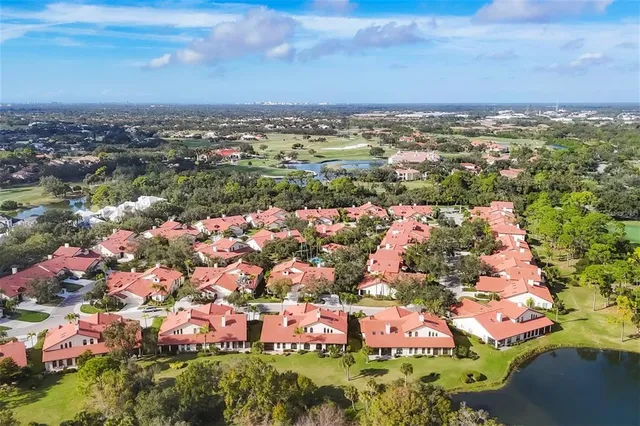 an aerial view of a house with garden space and lake view