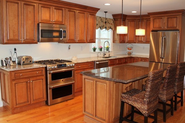 280 River St Extension Billerica, MA 01821 - Photo 8 of 23 a kitchen with stainless steel appliances granite countertop a stove a sink dishwasher and a refrigerator with wooden cabinets