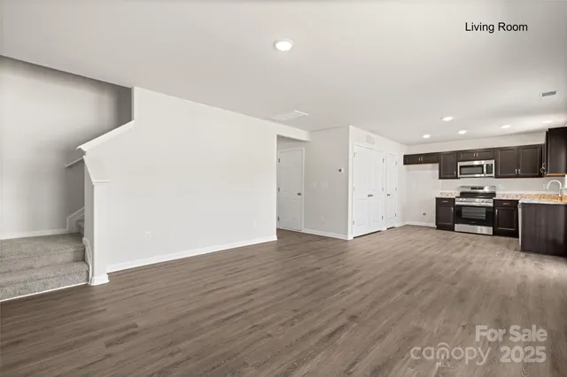 a view of a kitchen with a sink and a refrigerator